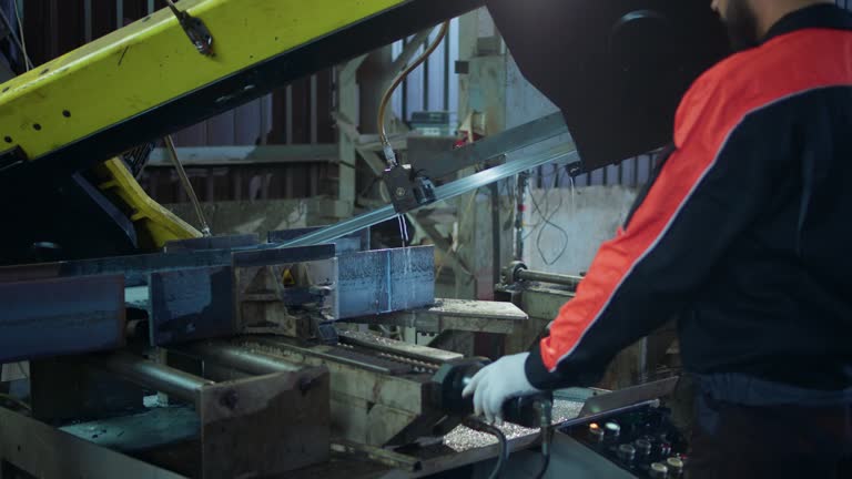 Big heavy machinery in production zone factory worker working he wearing the safety equipment and helmet