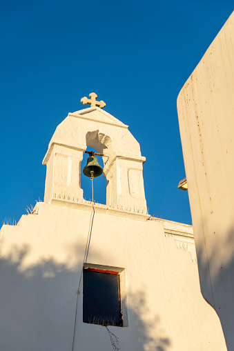 Greek church with anti-pigeon device and rusty bronze bell
