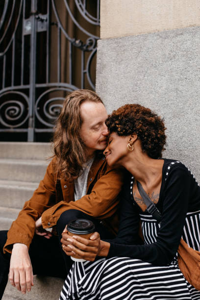 istock Affectionate embrace on city steps with coffee in hand 2081649124