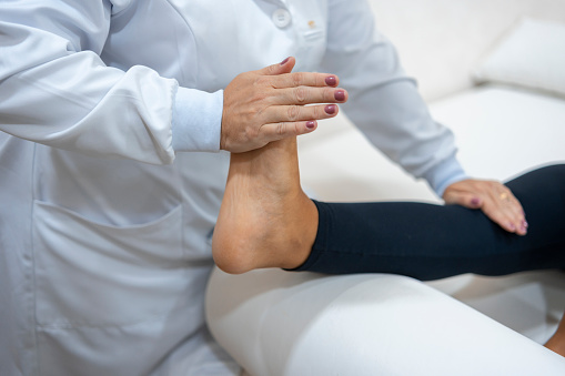 Woman treating her foot in physiotherapy clinic