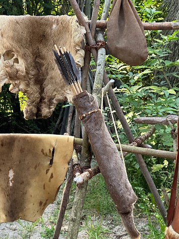 A traditional fence constructed from wooden sticks with a rustic touch added by incorporating a piece of fur from a terrestrial animal