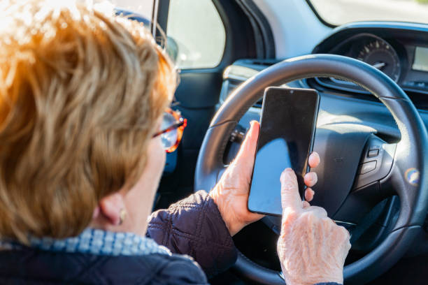 istock Elderly woman inside a car using a smartphone 2081678389