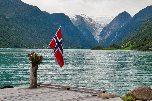 The Norwegian flag against the Norwegian landscape