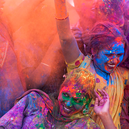 Friends covered in colored dye while celebrating the festival of Holi in Jaipur, India.