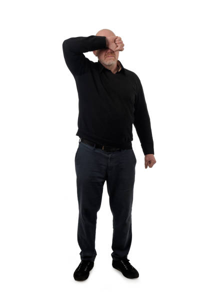 front view of a man covering her face with her arm on white background