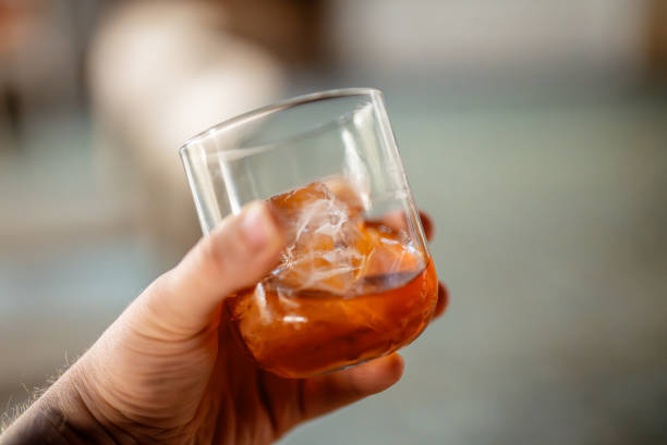 istock A man holds a classic Negroni cocktail with ice. 2081726126