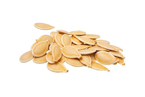 Fresh, raw pumpkin seeds isolated on white background.
