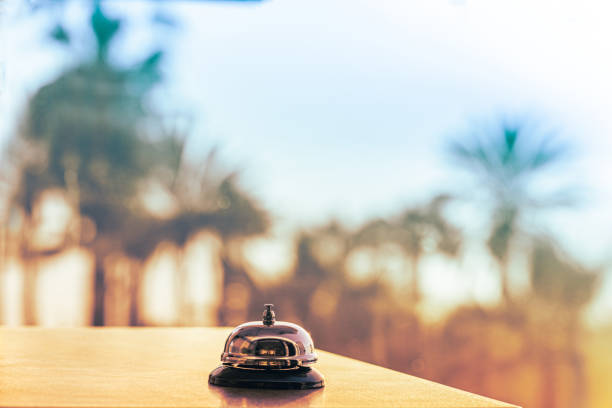 istock The desk beach cafe, restaurant with a service bell for warn that the dish is ready. Table reservation for dinner . Roof of cafe sea and palm tree view on sunset. 2081731539