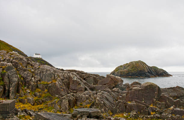 Lighthouse Krakenes on rocky coast of Atlantic ocean