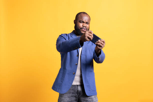 istock Gamer enjoying game on mobile phone, having fun, isolated over studio background 2081752762