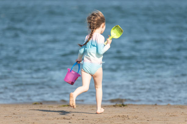 Girl enjoys a Summer afternoon at the beach.