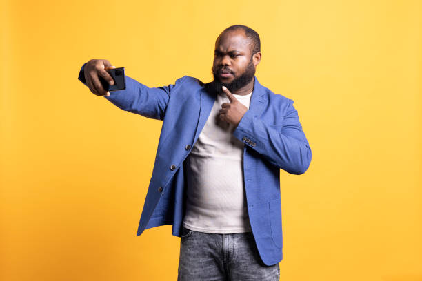 istock Vain person taking selfies with phone, narcissism concept, studio background 2081760563