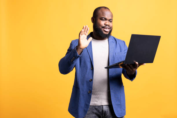 istock Man discussing with coworkers during video conference meeting, studio background 2081763855