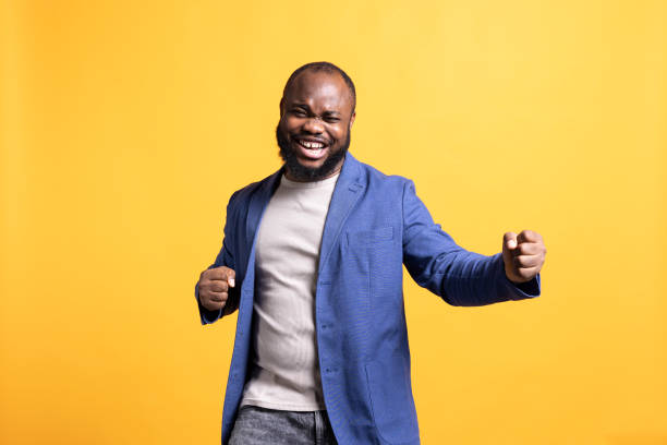 istock Overjoyed man enjoying success, cheering and gesticulating, studio background 2081765480