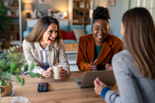 istock Group of female colleagues using laptop and smiling 2081775763