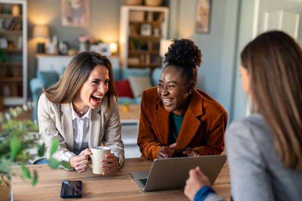 istock Three diverse female colleagues laughing in a modern office 2081776290