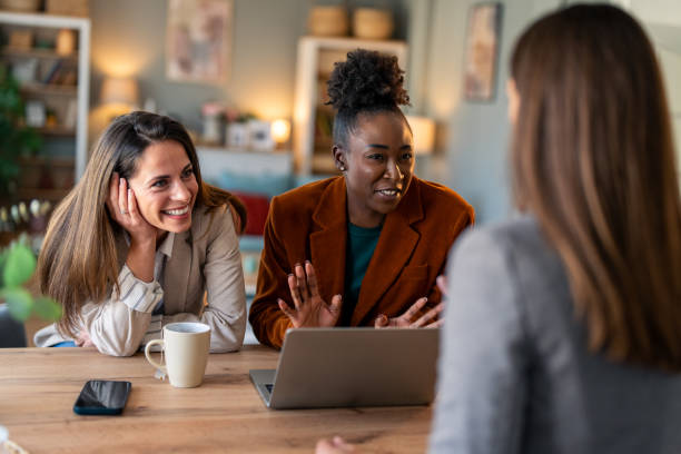 istock Group of happy diverse business women smiling while sitting together in an office 2081776310