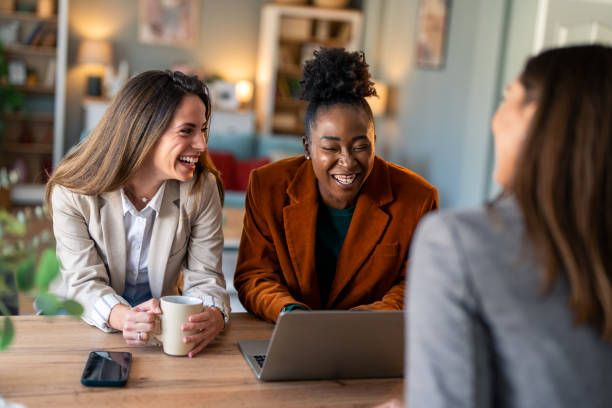istock Three multi-ethnic business women are having cheerful discussion in the office 2081776312