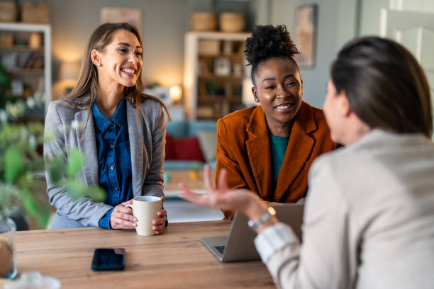 istock Three happy females smiling while having a discussion 2081776860