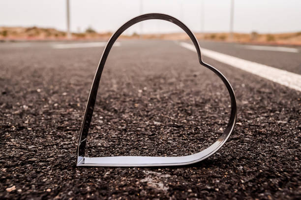 Heart Symbol on the Grainy Asphalt Texture. Love for Travel Concept