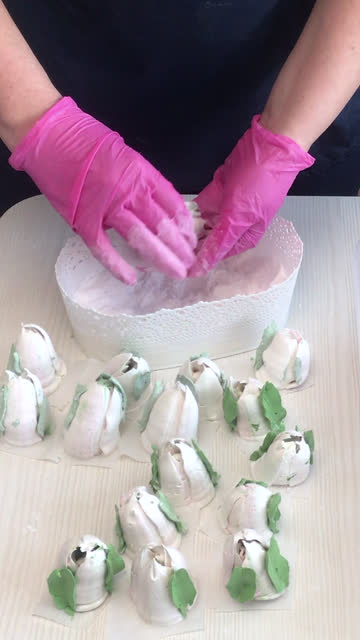 A woman processes marshmallow mesh. Tulips from marshmallows. Homemade marshmallows. Vertical video