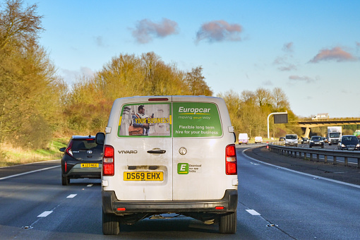 Swindon, England, UK - 10 January 2024: Rear view of a rented van owned by the Europcar rental business driving on the M4 motorway