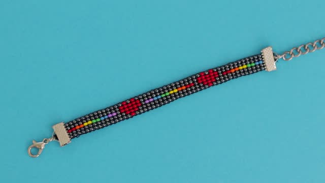 LGBT bead pattern bracelet in blue background. Close up