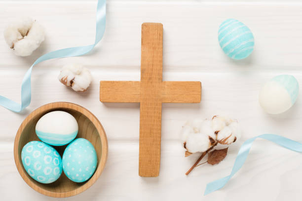 istock Easter eggs with cross on wooden background, top view 2081857960