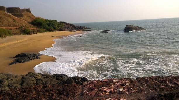 istock an open beach with waves crashing on it and a rocky shoreline in the foreground 2081864263