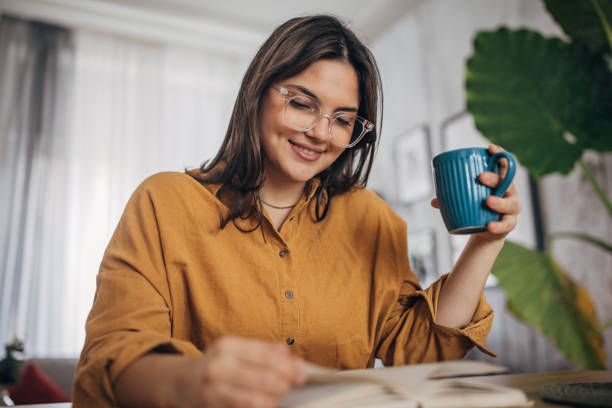 istock Young woman reading a book 2081930572