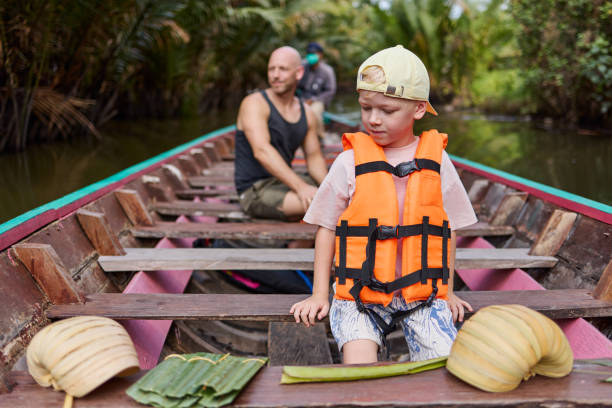 istock A little boy sits on a boat with a life jacket 2081946445