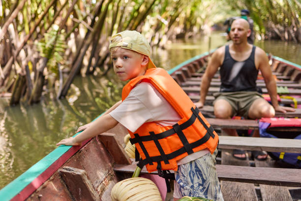 istock A little boy sits with a life jacket on a longtail boat 2081948119
