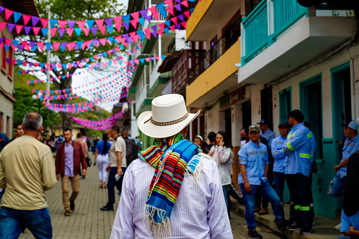 Jerico, Colombia - January 14, 2023: Peasant with hat and poncho walks through the streets of the town
