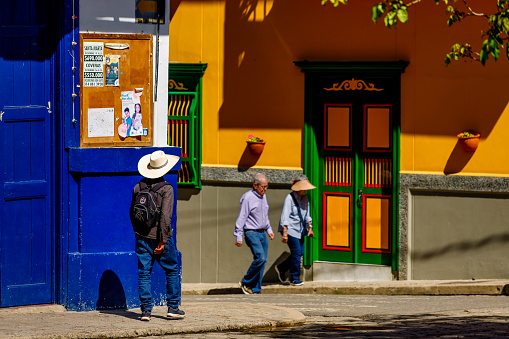 Jardin, Colombia - January 13, 2023: Farmer and tourists walk through a corner of the town