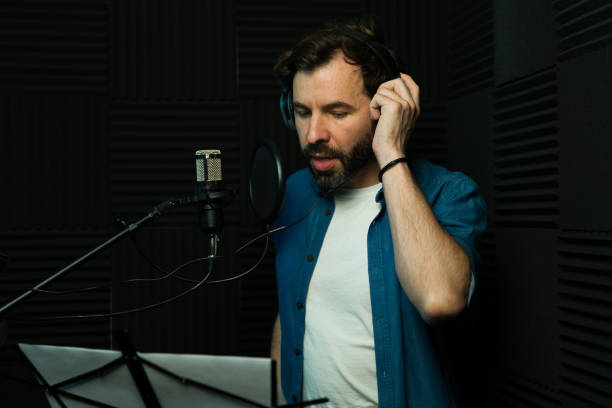 istock Male voice-over artist recording in studio 2081960400