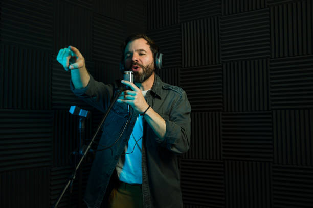istock Male vocalist recording in studio and pointing towards an audience 2081965793