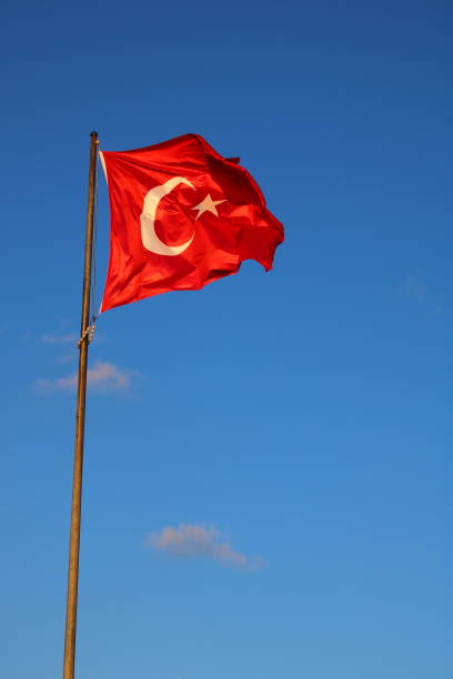 istock Turkish national flag waving in the blue sky 2081984417