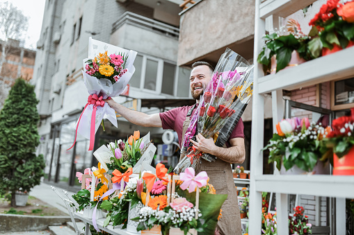 Smiling Male Florist Offering His Best Flowers For International Women's Day