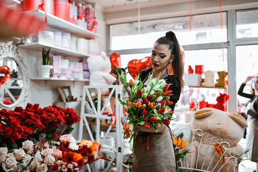 A Bouquet Of Lilies Checked By Female Florist