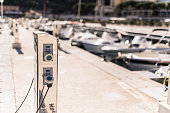 Charging station for boats. Electric sockets for charging ships on Monaco Harbor.