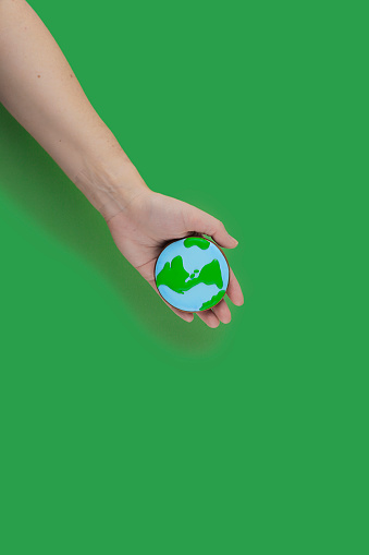 Earth Day concept. Ð¡ookie in shape of Earth in hand.