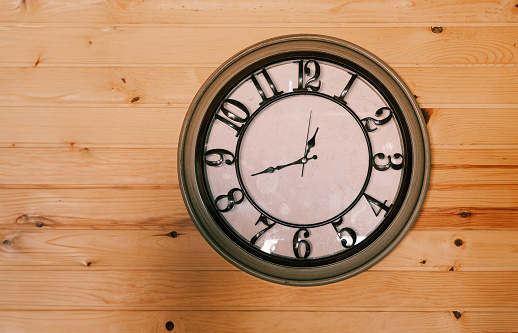 Black and white clock on wooden wall, free copy space