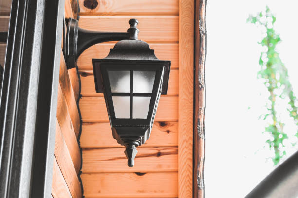 istock A wall of a log cabin with a black sconce lamp on the wall 2082041923
