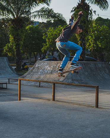 Balikpapan, Indonesia -February 17th, 2024. he jumps high playing in the skate park