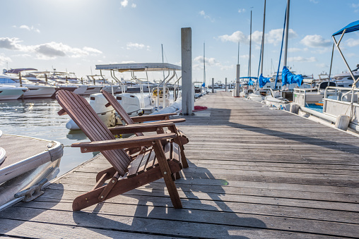 Pair of wooden chairs in a luxury Miami sports marina