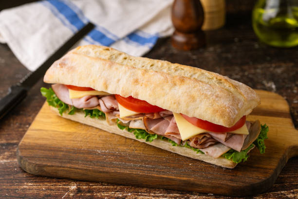 submarine sandwich with turkey and black forest ham submarine sandwich with turkey and black forest ham torpedo sandwich stock pictures, royalty-free photos & images