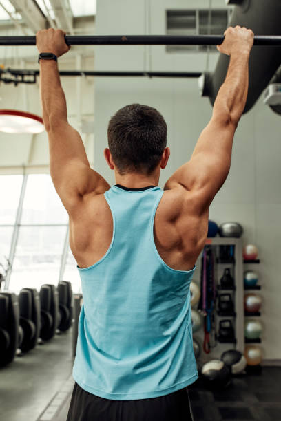 istock work with own weight, the athlete does exercises on the uneven bars. 2082090053