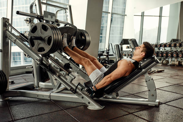 Close up photo of a lat pulldown machine with weight plates attached, focusing on the equipment details