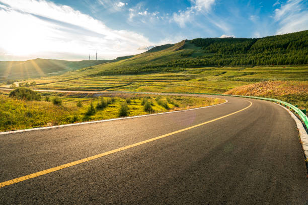 Grasslands and Road Grasslands and Road empty road with trees stock pictures, royalty-free photos & images