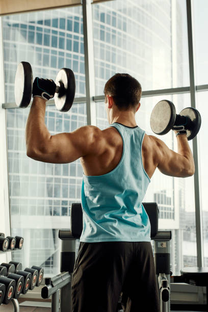 istock Close up of man using dumbbell exercise at gym, Sport concept 2082121638